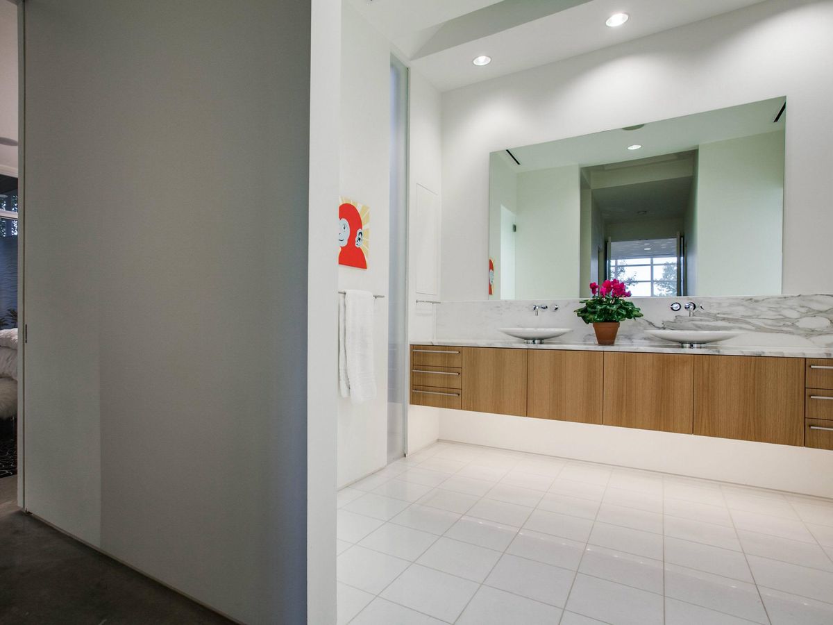 Dual vessel sinks are the star of this marbleheavy master bath