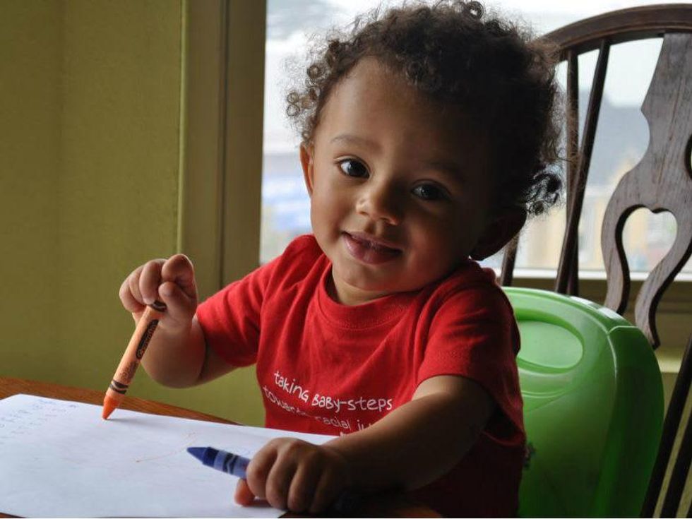 A baby wearing an ARC T-shirt