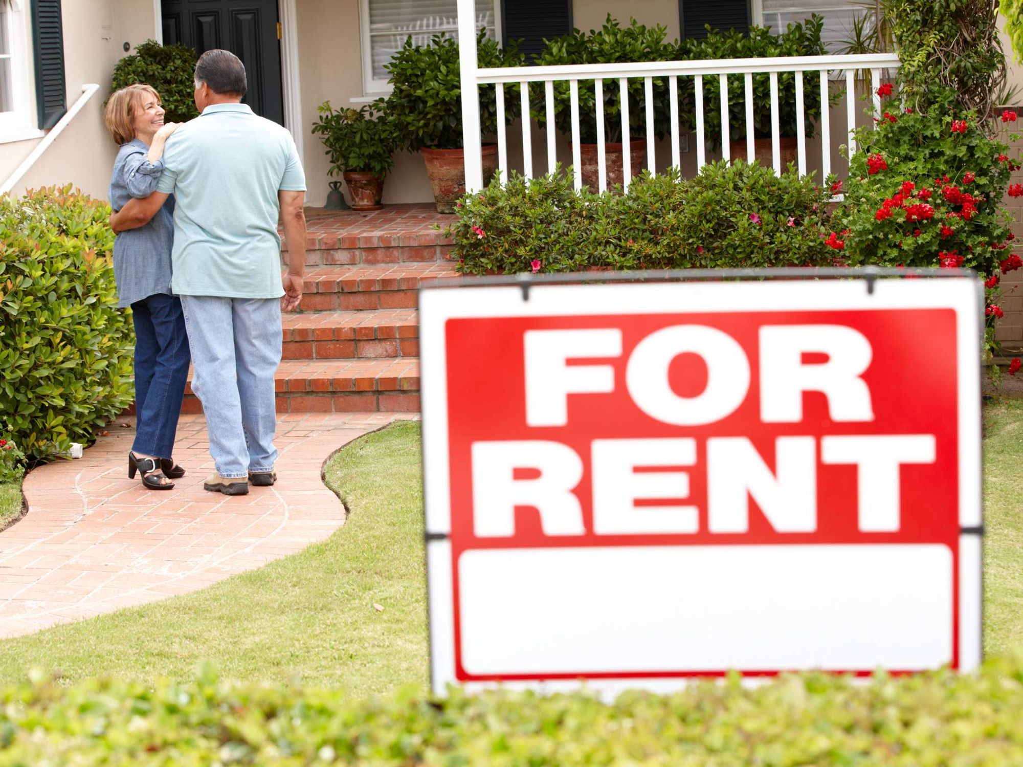 A senior couple inspecting a potential house rental