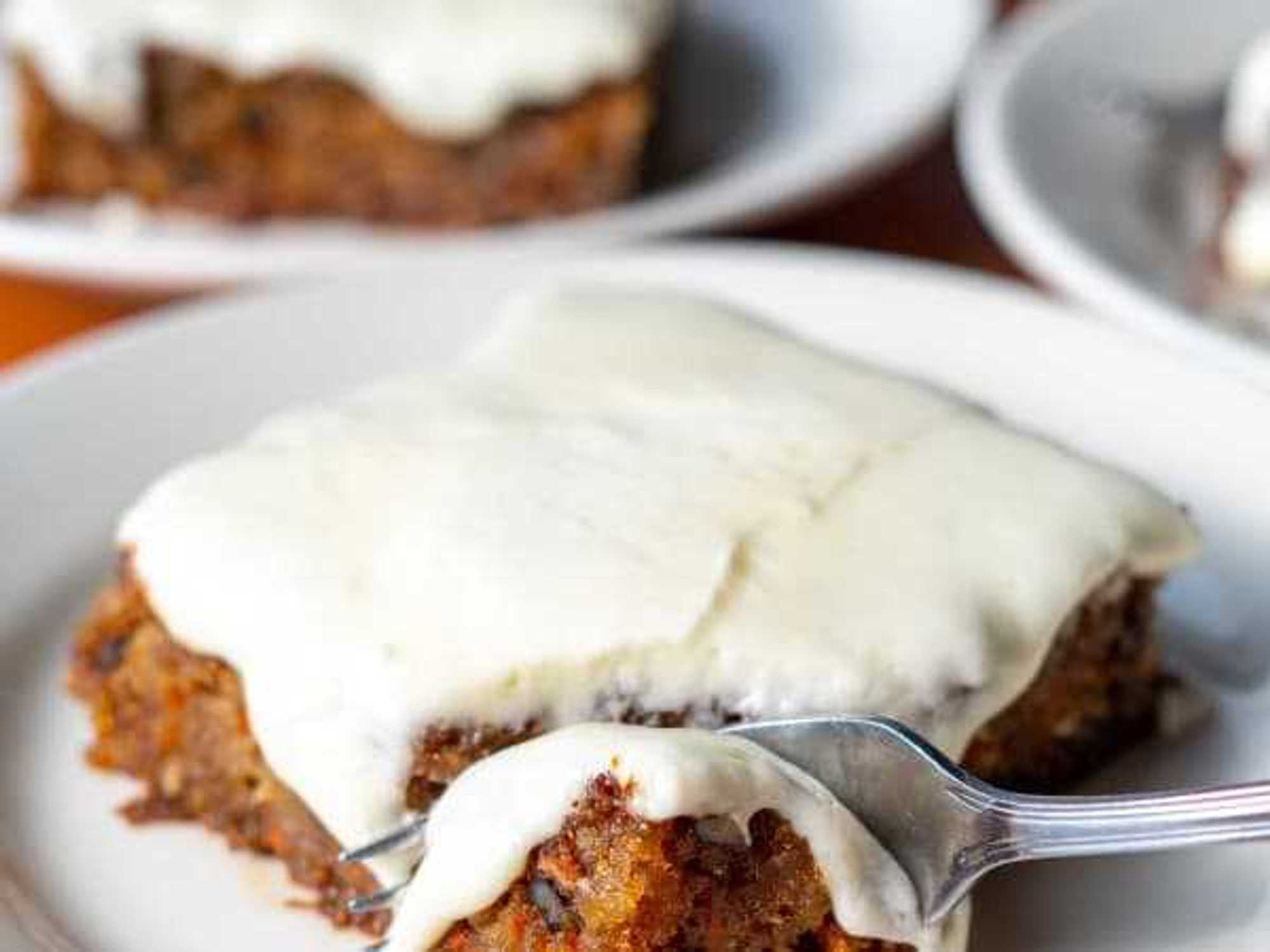 A slice of carrot cake covered in icing