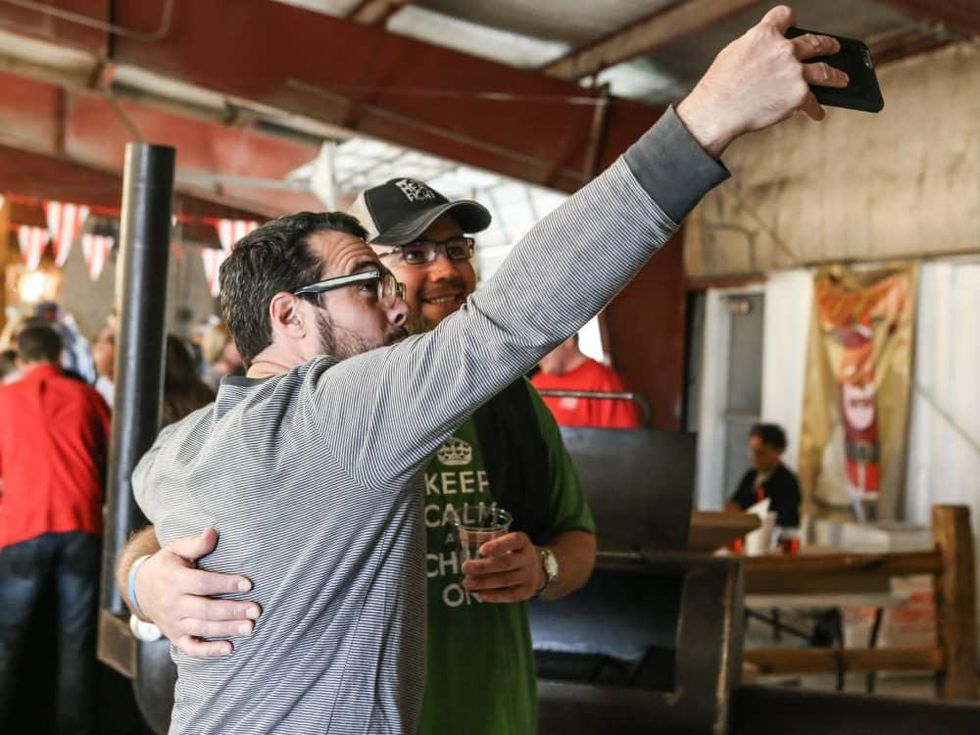 Aaron Franklin taking selfie with guest at Meat Fight 2015