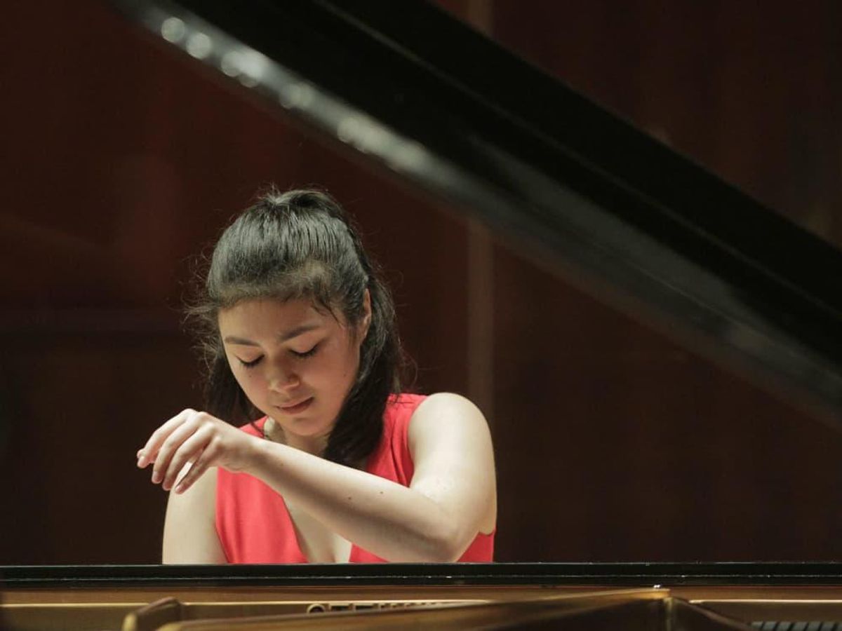 Avery Gagliano, 17, of the United States tests out a piano in Caruth ...