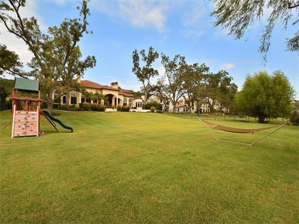 Backyard with play area at 8300 Big View Dr. in Austin