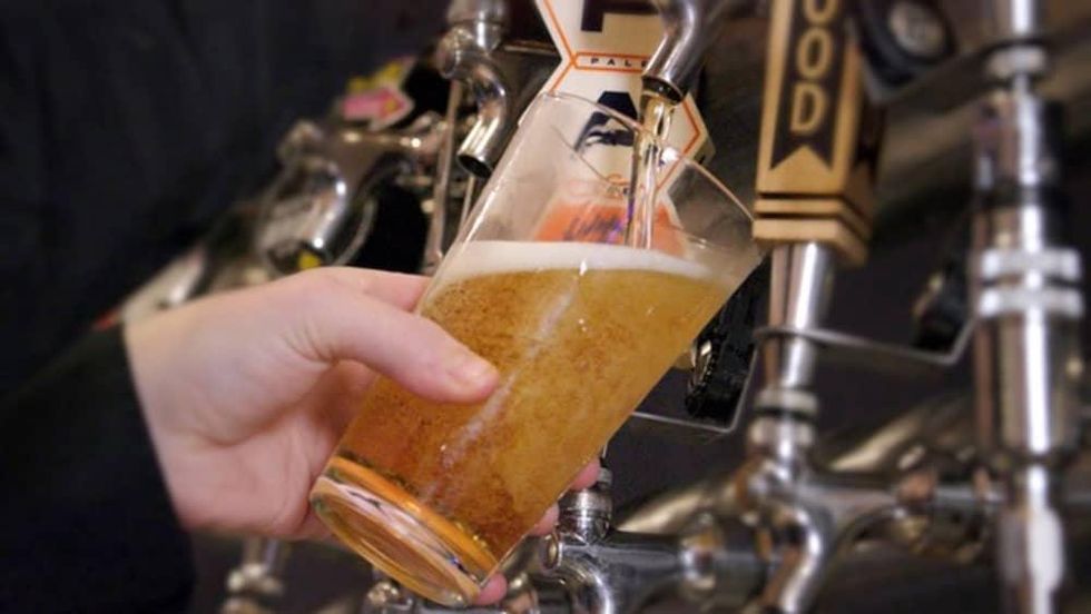 Bartender filling a beer glass