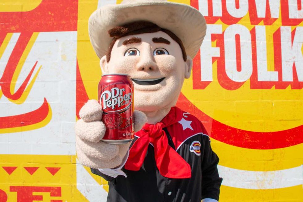 Big Tex holding a Dr Pepper can