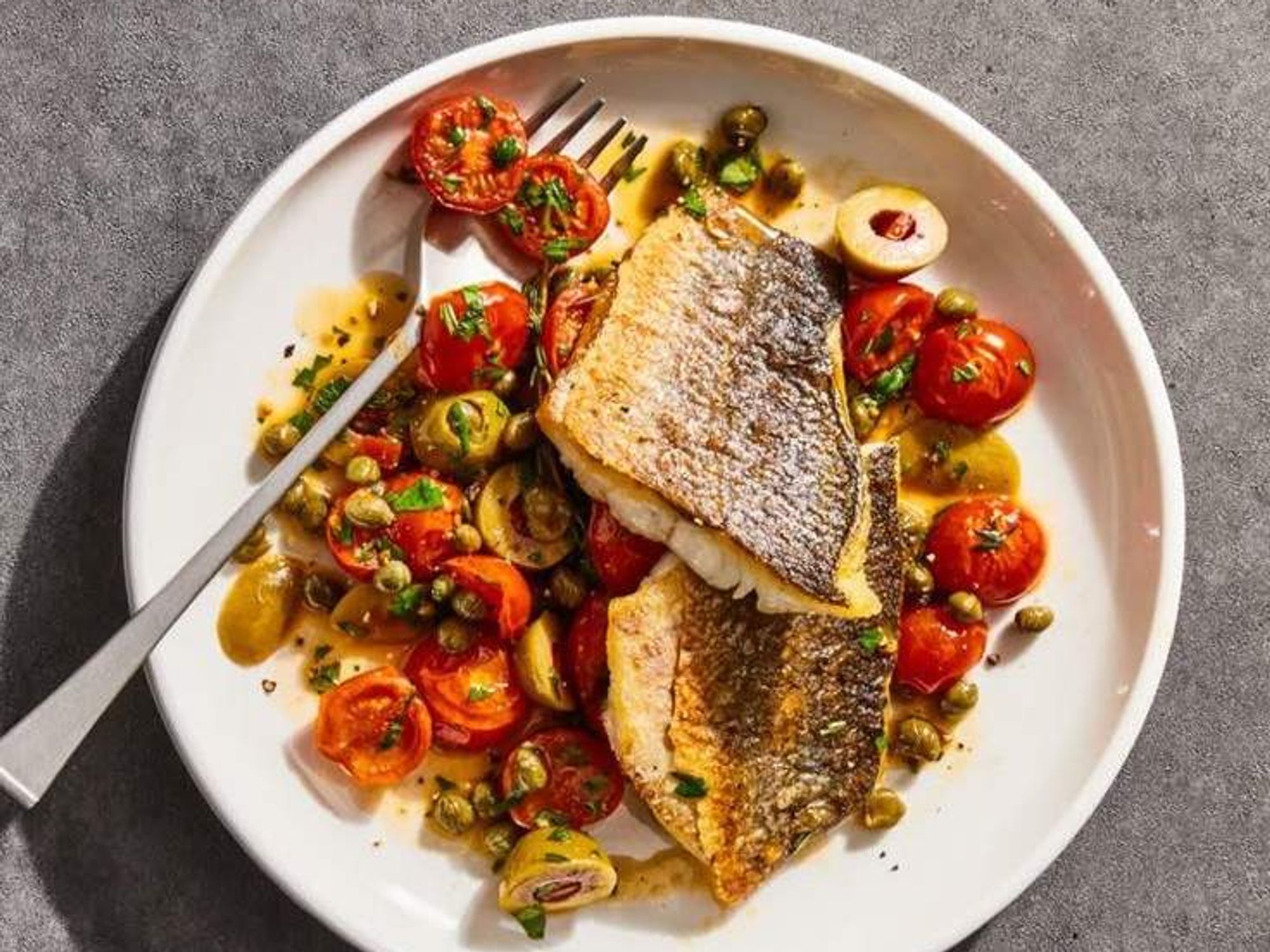 Branzino with olives and tomatoes