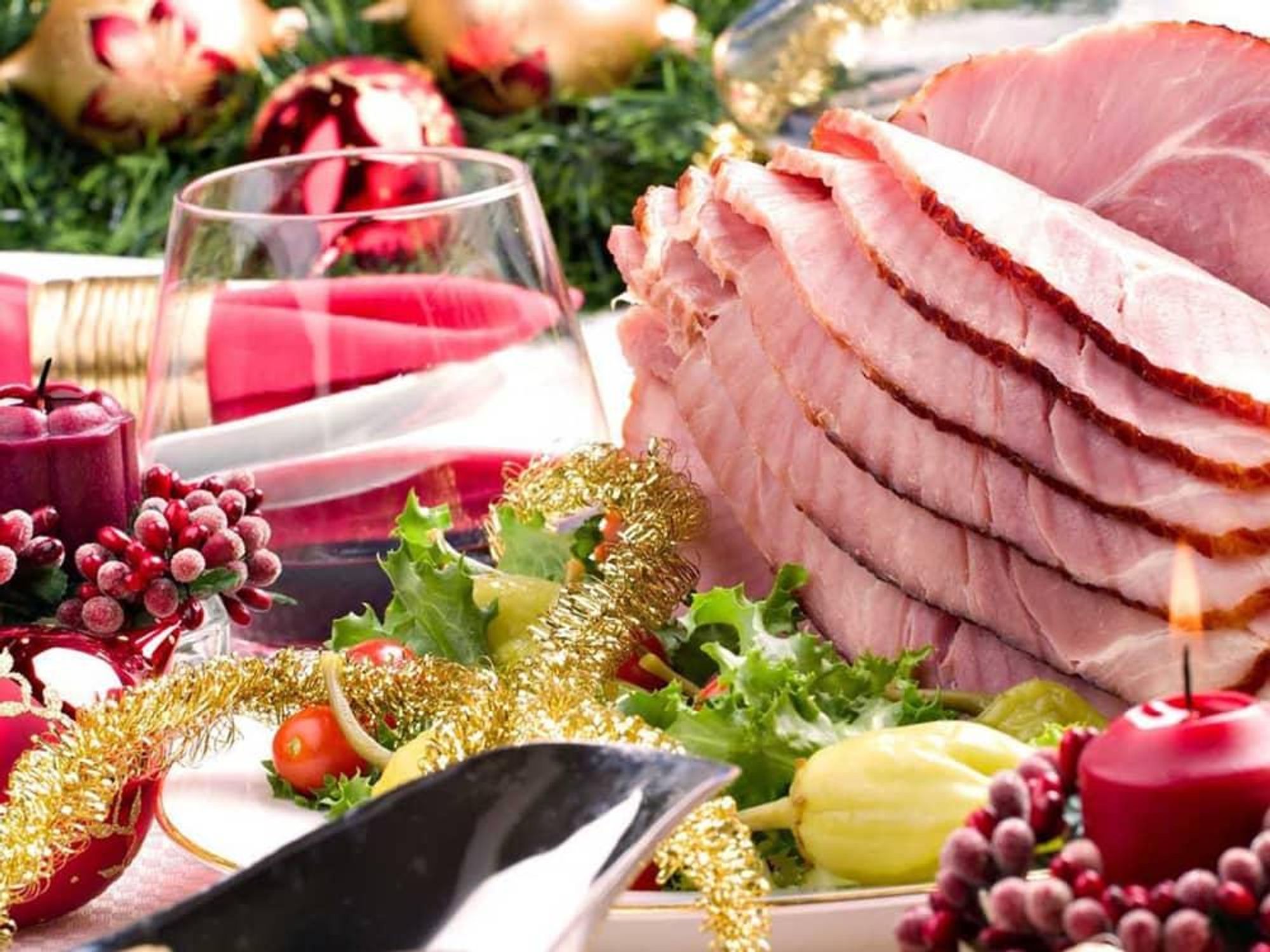 Christmas dinner with ham and red wine and candles