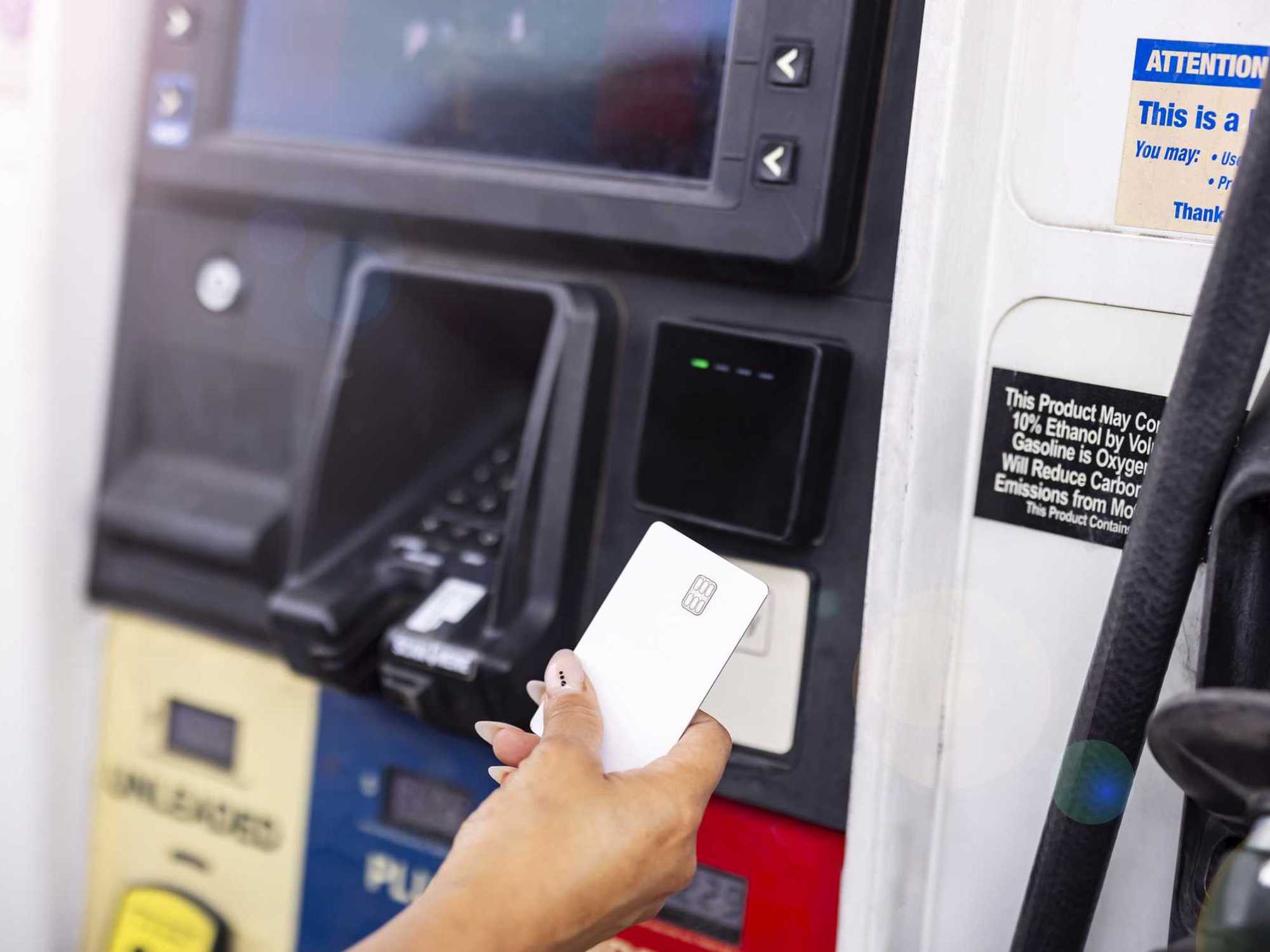 Close-Up of Woman Paying For Gas With Credit Card