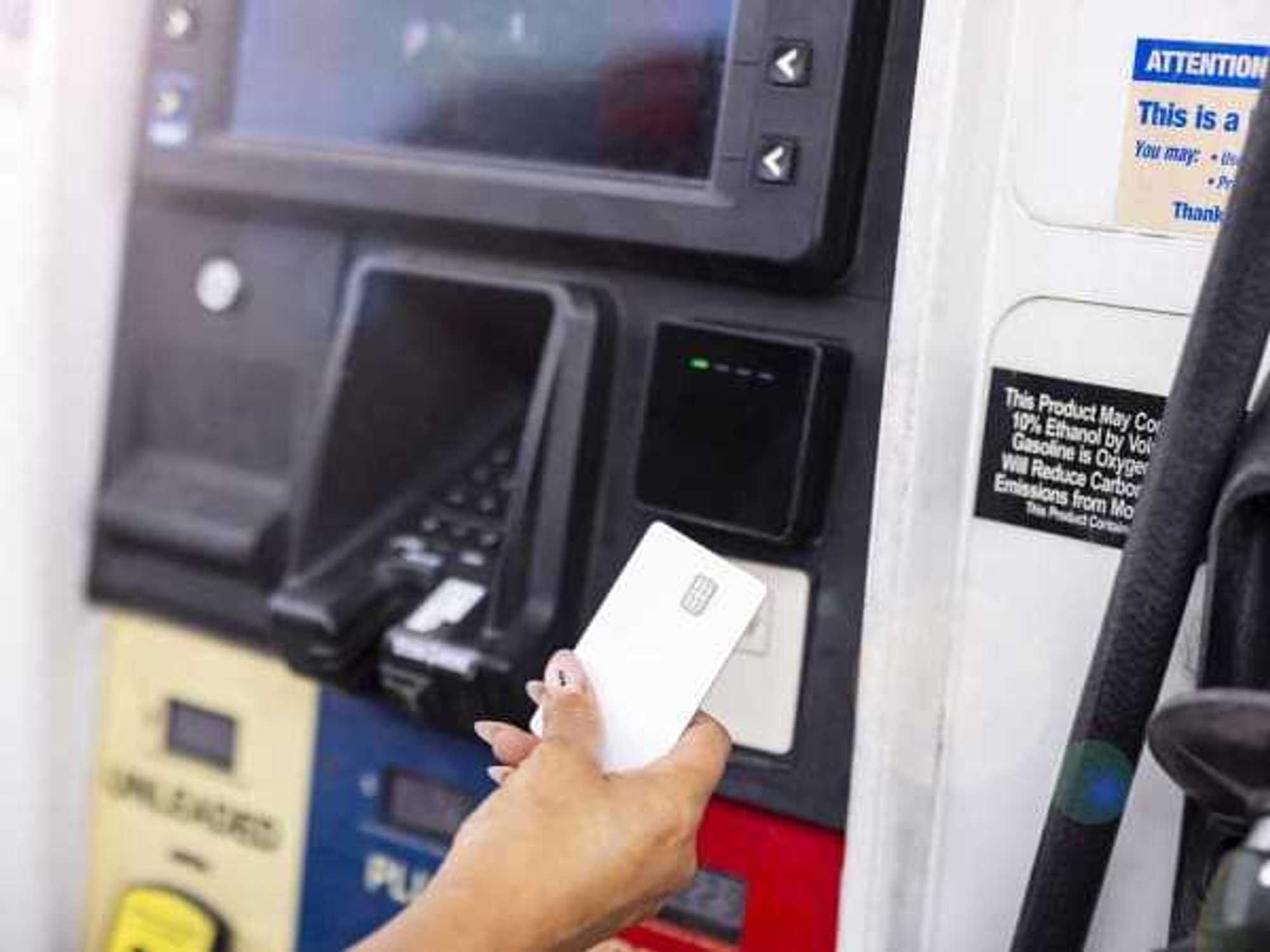 Close-Up of Woman Paying For Gas With Credit Card