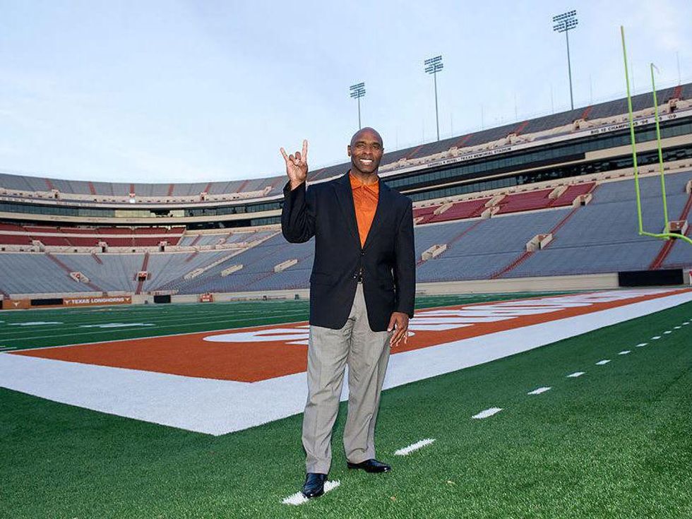 Coach Charlie Strong giving hook 'em at DKR Stadium