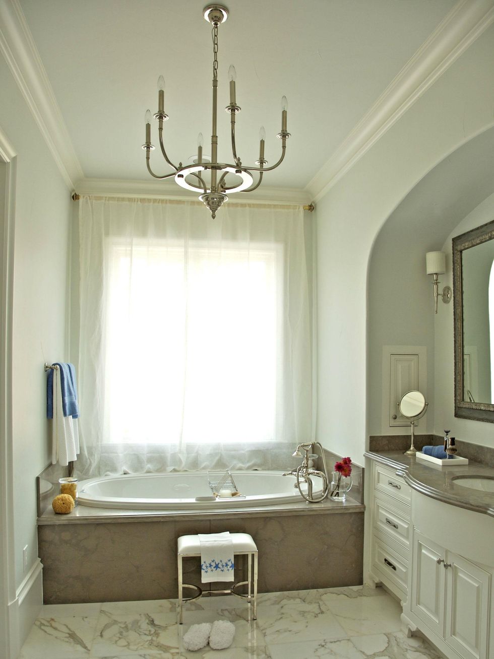 Custom bathroom with marble and chandelier