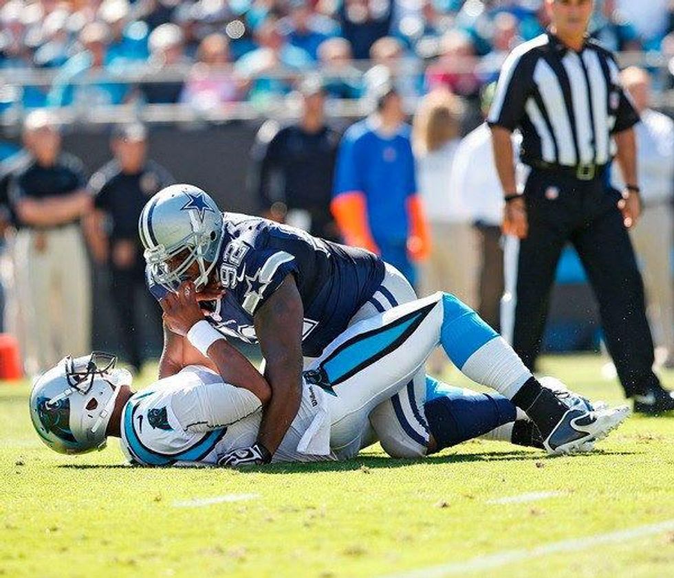 Dallas Cowboy Josh Brent sacks Carolina Panther Cam Newton