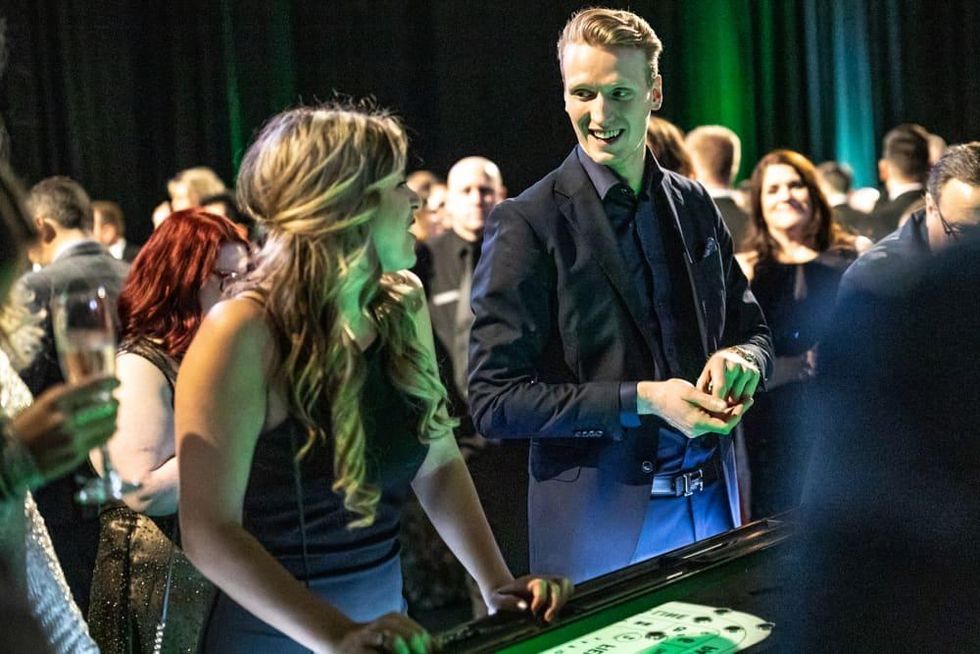 Dallas Stars fan Jordan Morley plays craps with Dallas Stars player John Klingberg