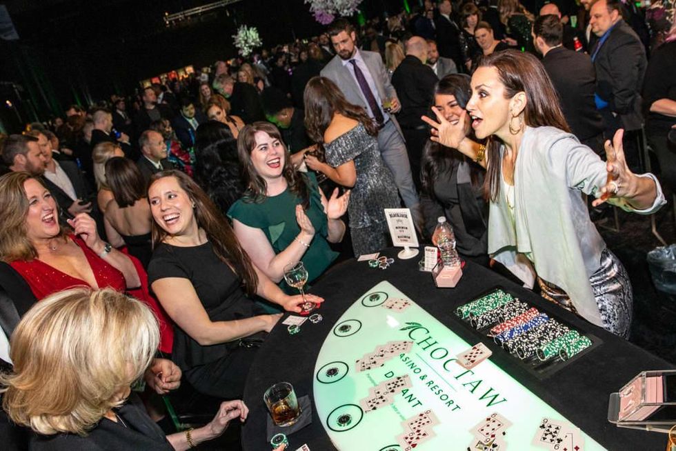 Dallas Stars in-game host and National Anthem singer Celena Rae deals blackjack