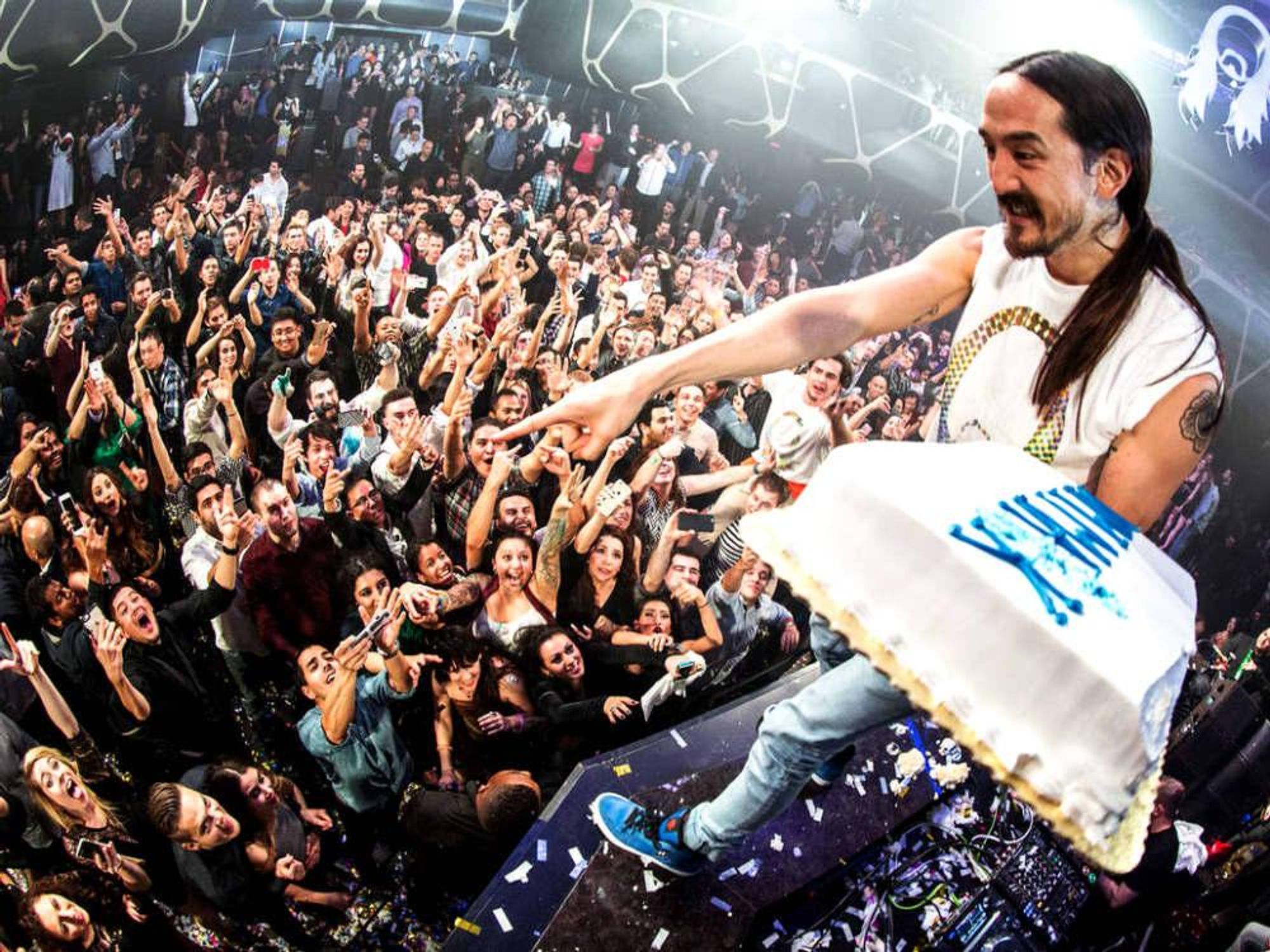 DJ Steve Aoki holding cake