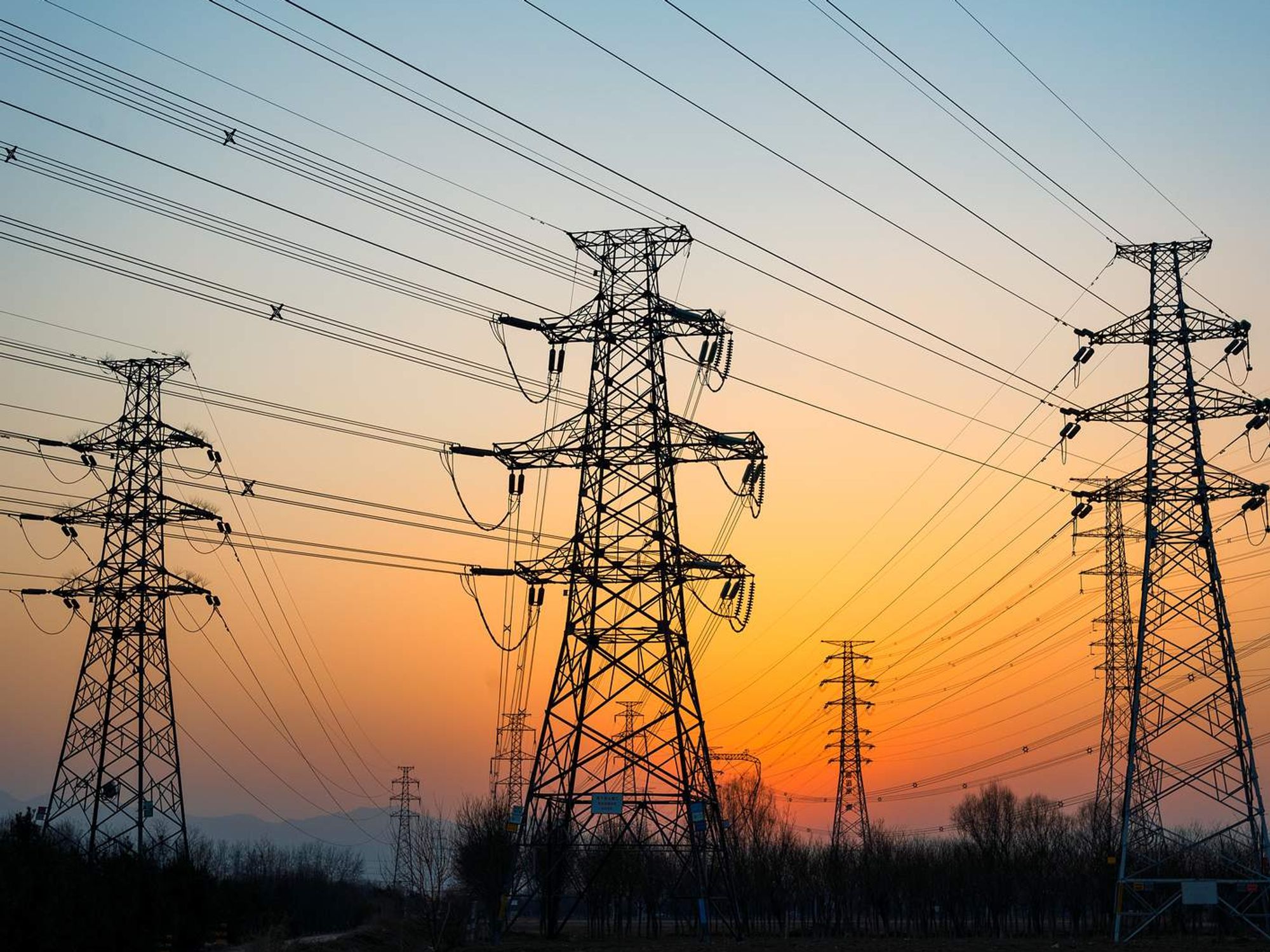 Electric wire towers in the sunset