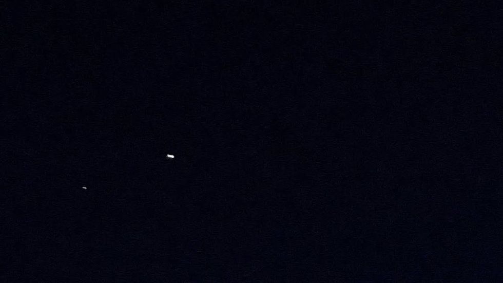 Meteor splits in two over moonstruck Dallas sky