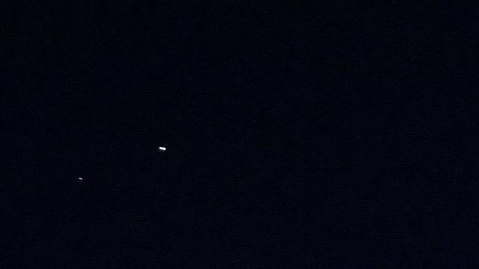 Meteor splits in two over moonstruck Dallas sky