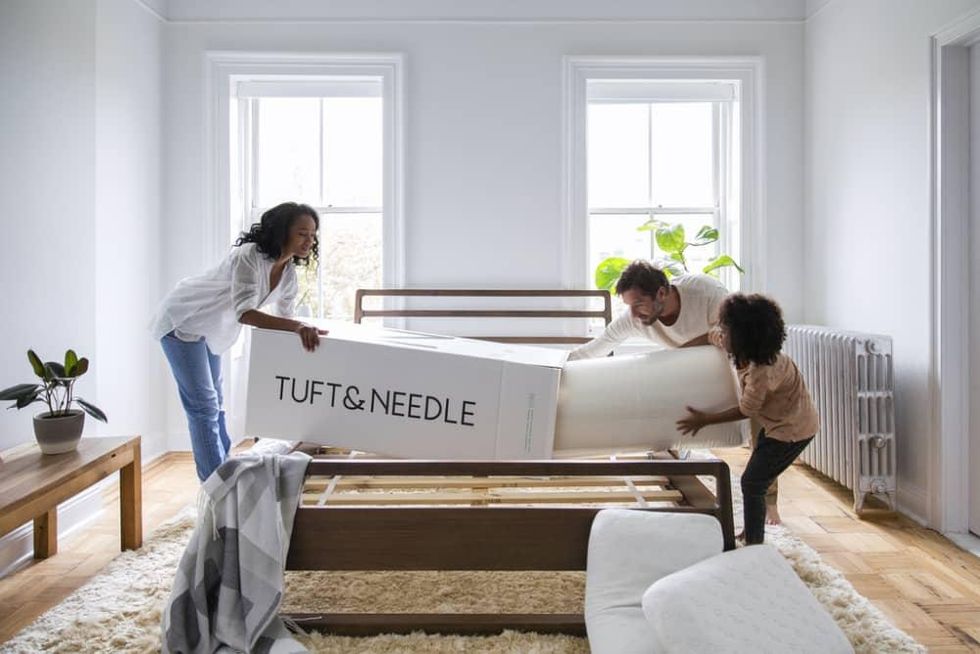 Family unrolling Tuft & Needle mattress