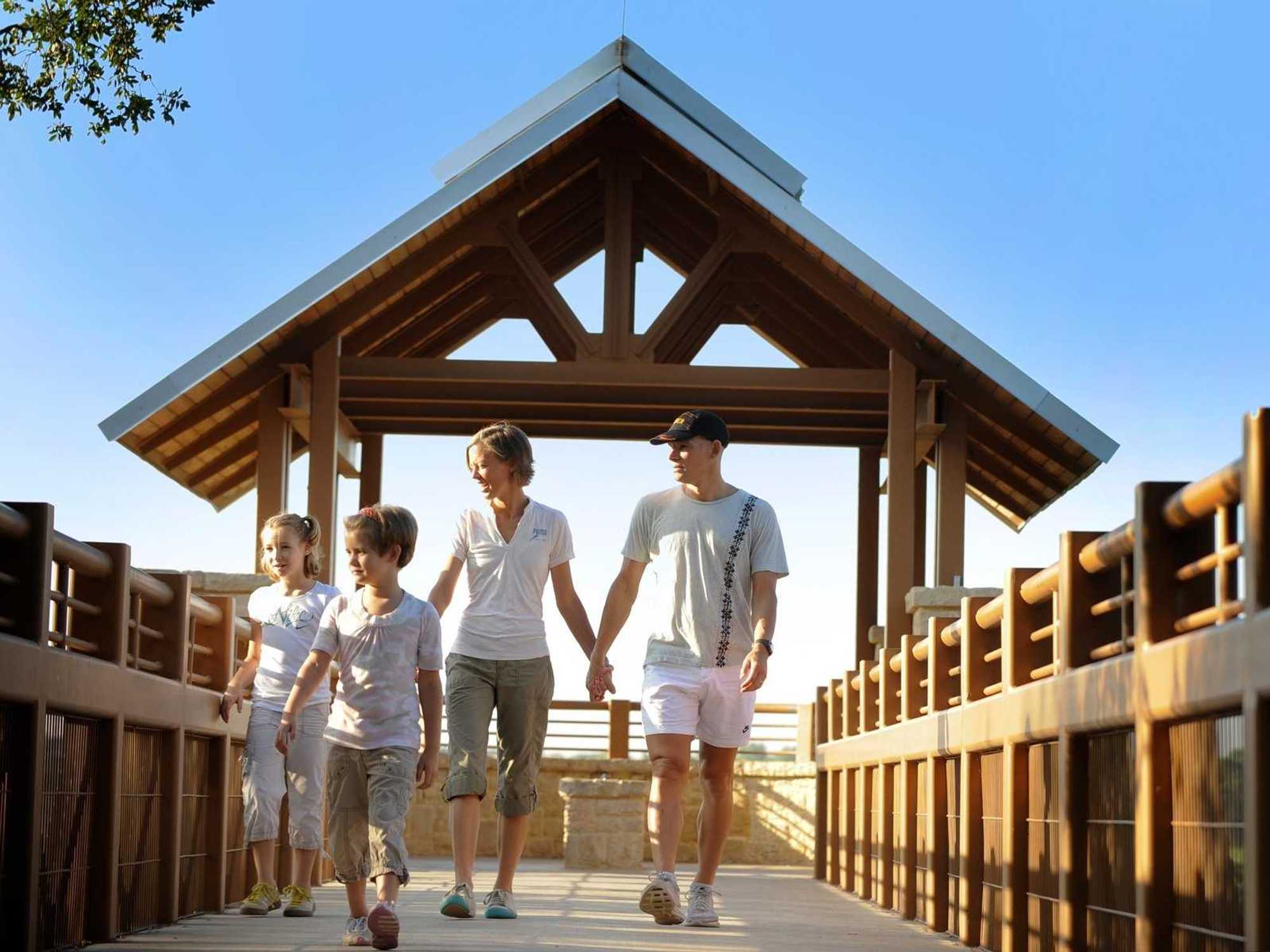 Family walking on the boardwalk at Arbor Hills Nature Preserve in Plano