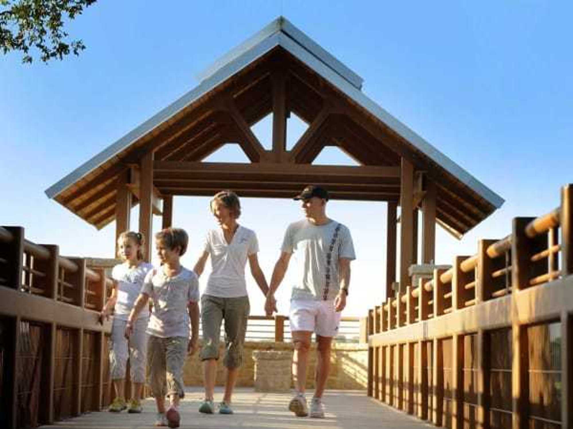 Family walking on the boardwalk at Arbor Hills Nature Preserve in Plano