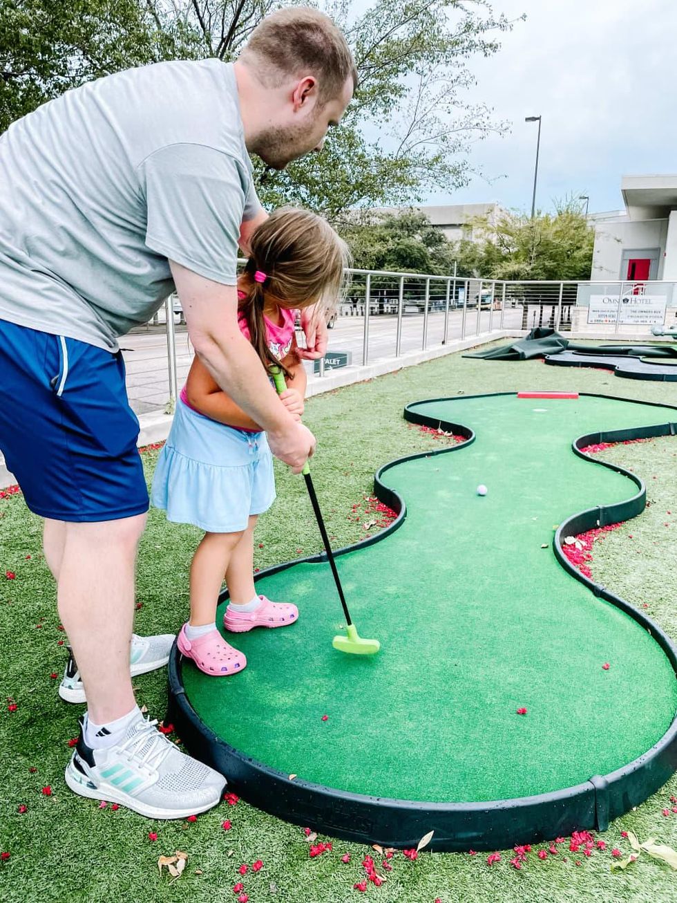 Father and daughter putt-putt