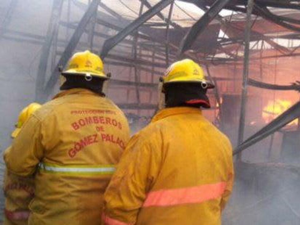 Firefighters fight to contain the fire's blaze