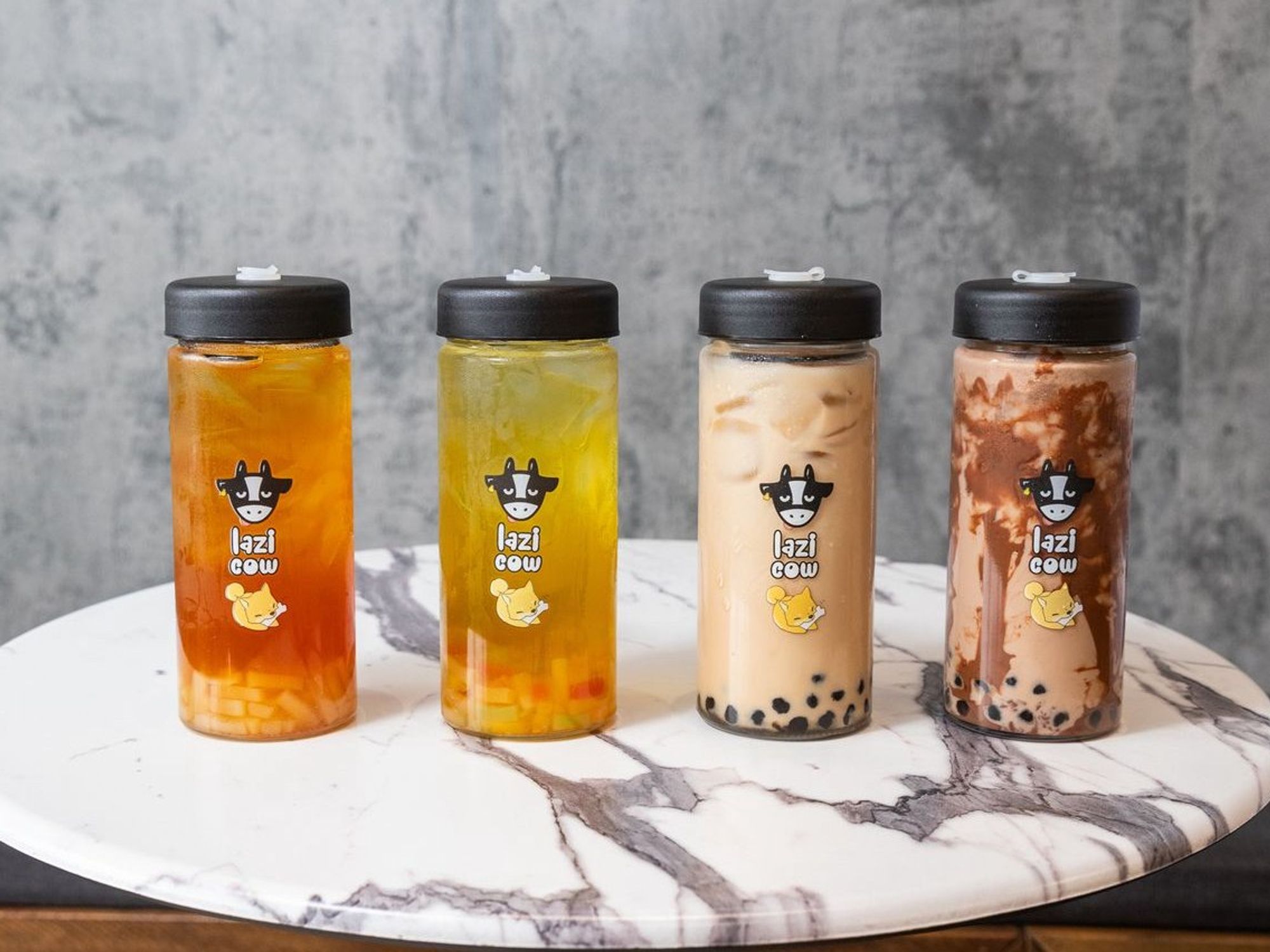 Four Lazi Cow drinks on a marble table