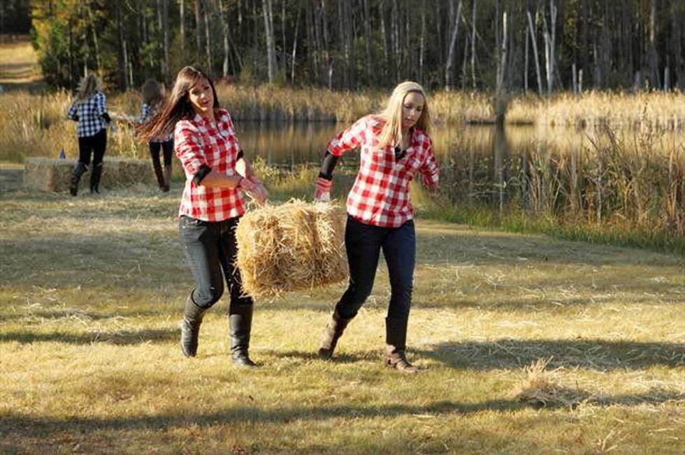Girls carry bales of hay on the Bachelor