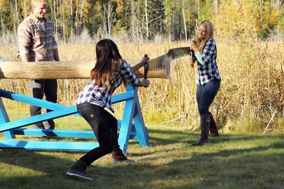 Girls cut logs on the Bachelor