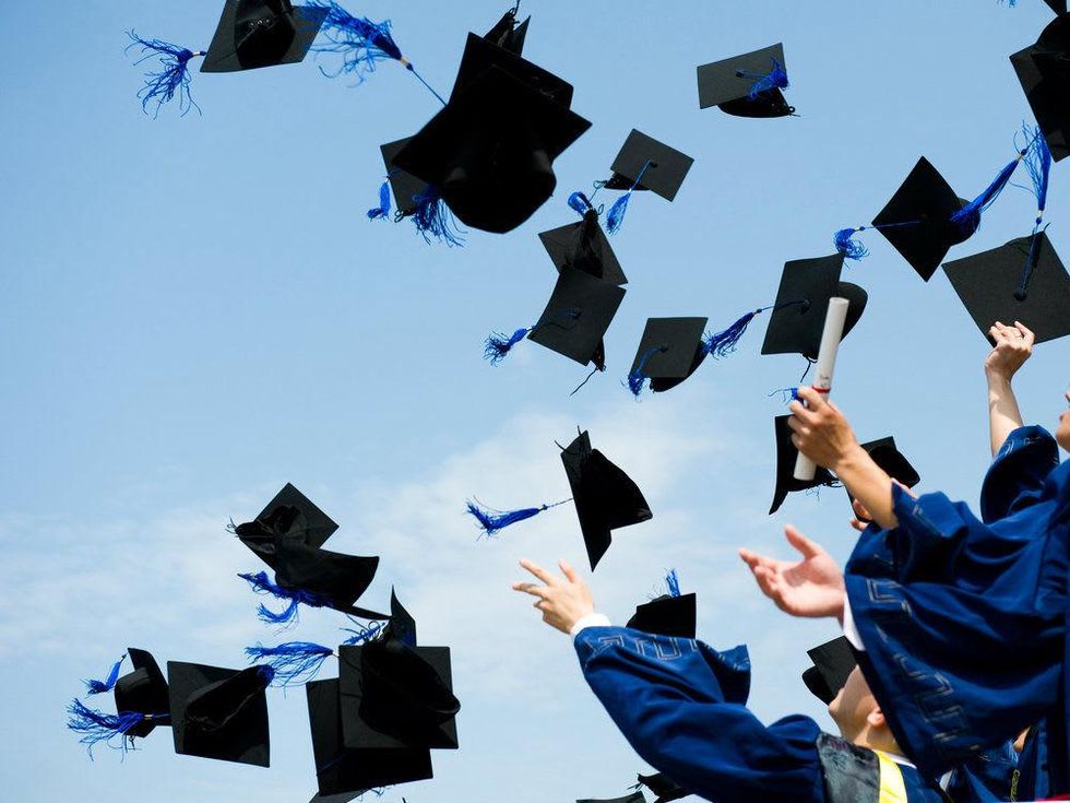 Graduates throwing caps in the air