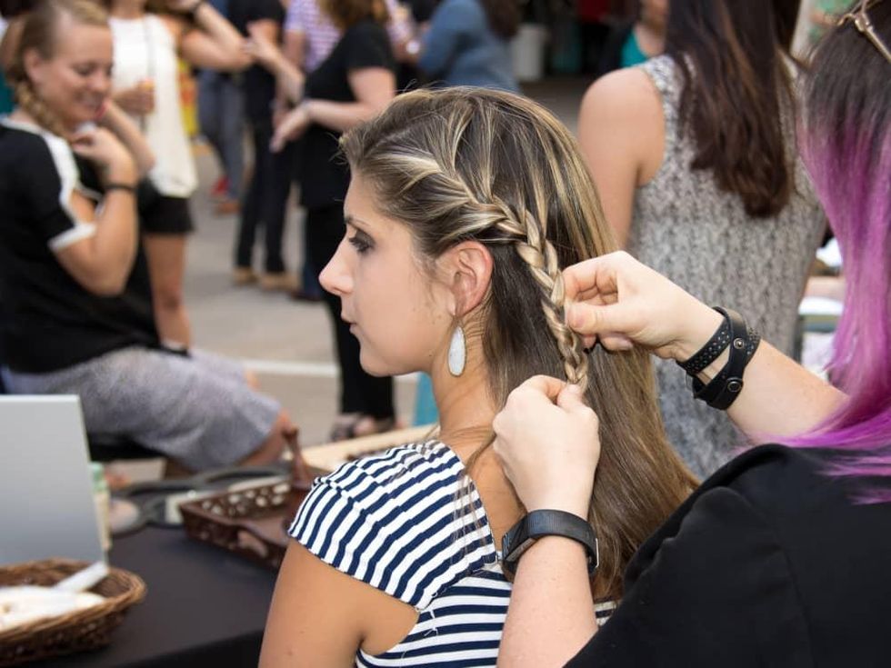 Guest having her hair braided at Hello Summer Social