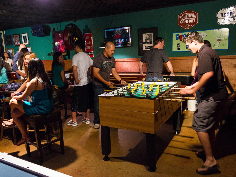 Guys playing game at Bryan Street Tavern in Dallas