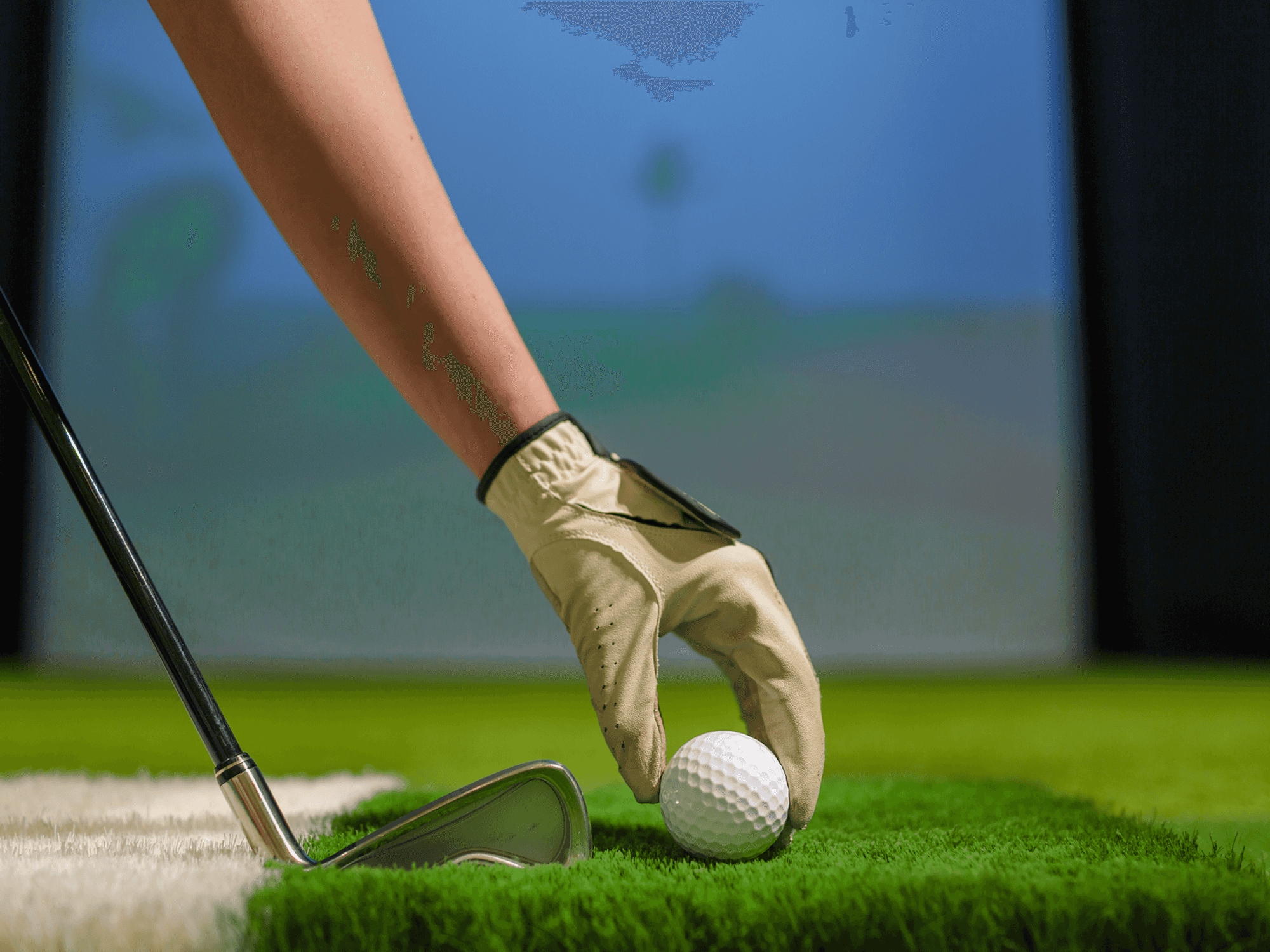 Hand teeing up a golf ball