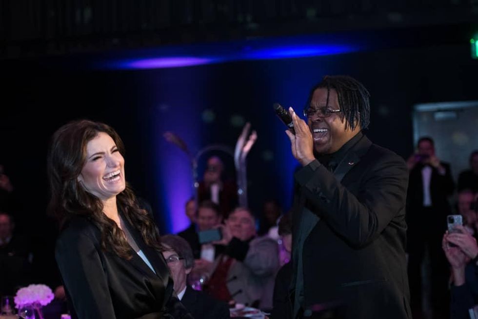 Idina Menzel singing with TCC member Gregory Perry.