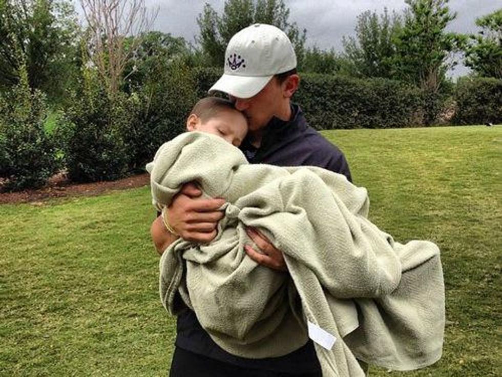 Johnny Manziel holds a sick child