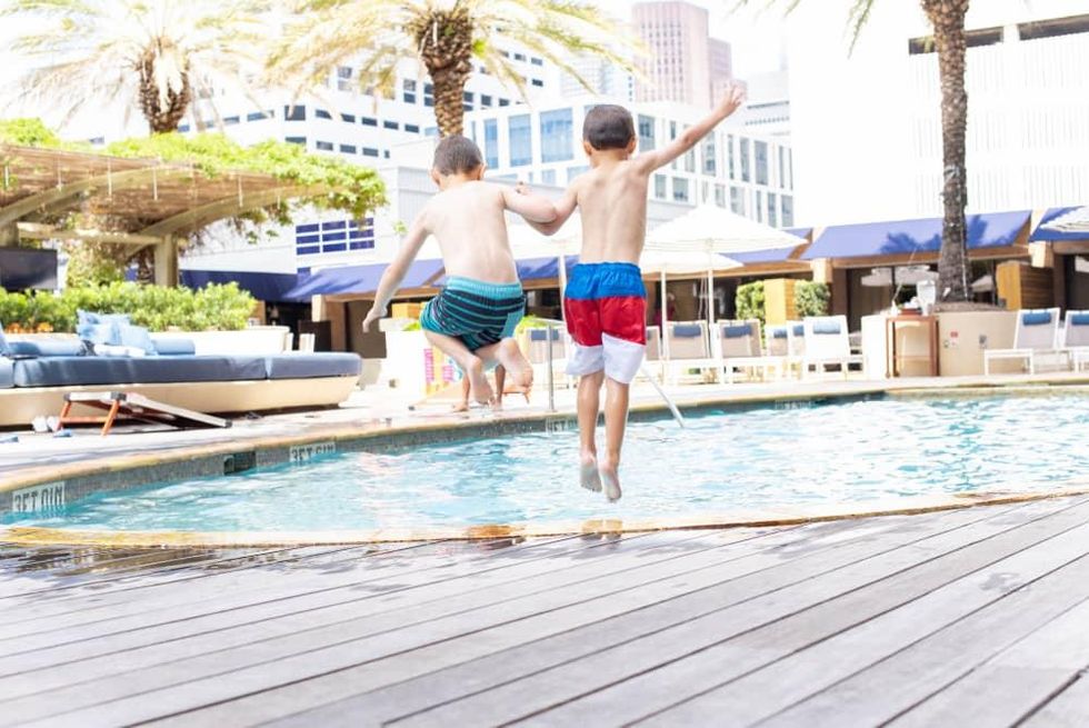 Kids jumping into the pool