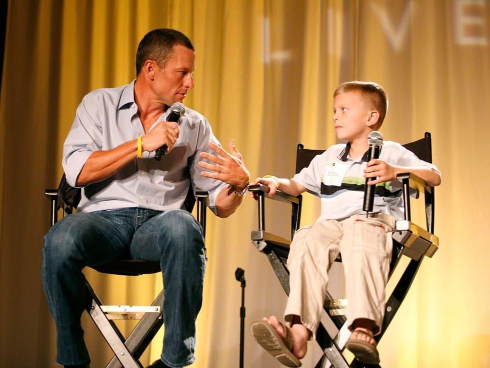Lance Armstrong and unnamed child at Livestrong event