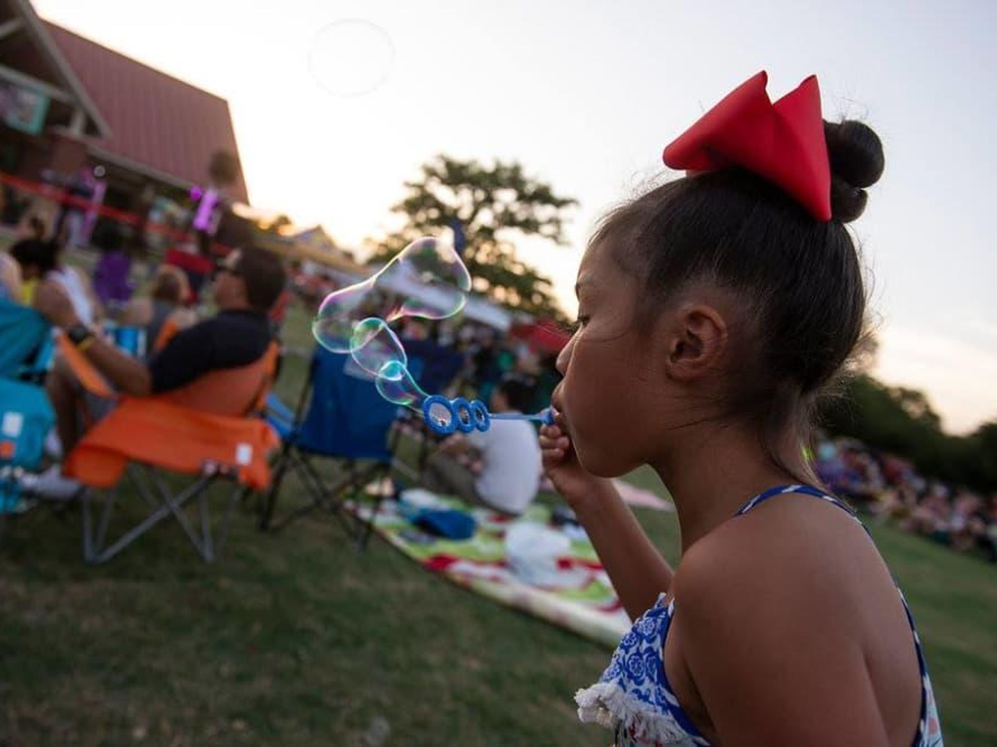 Little girl blowing bubbles