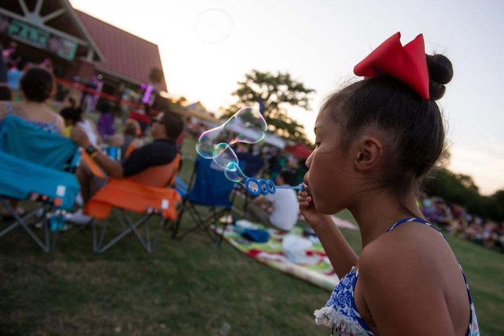 Little girl blowing bubbles