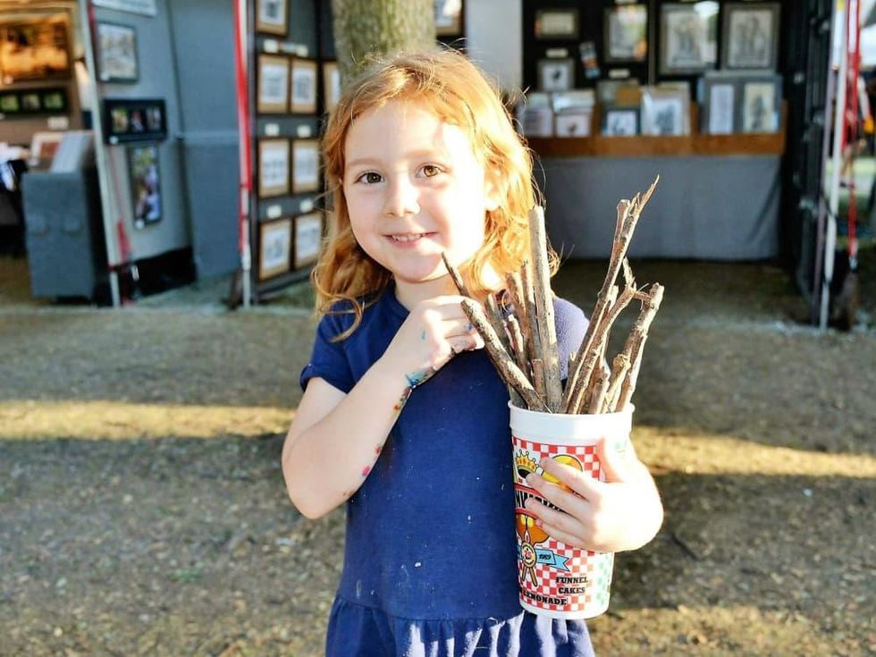 Little girl holding sticks