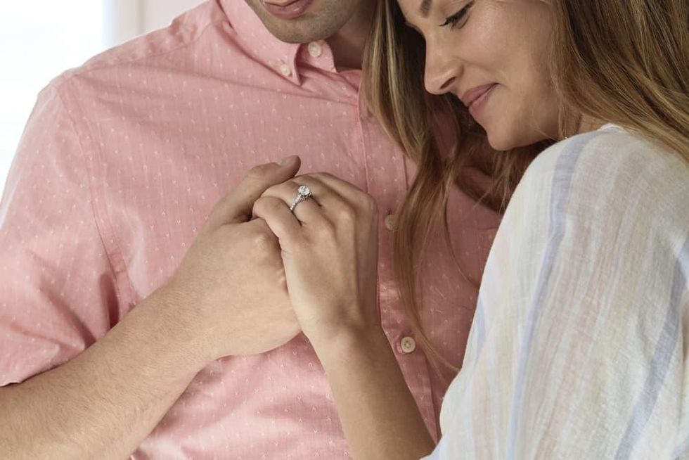 Man and woman looking at engagement ring