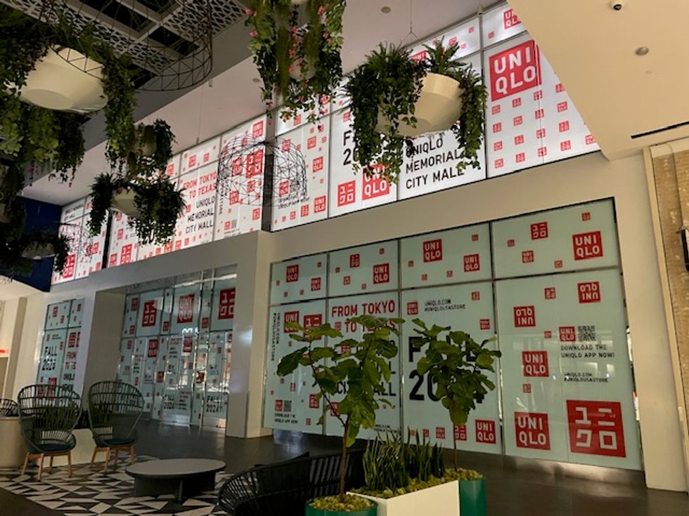 Memorial City Mall Uniqlo store, covered in logos and coming soon announcements.