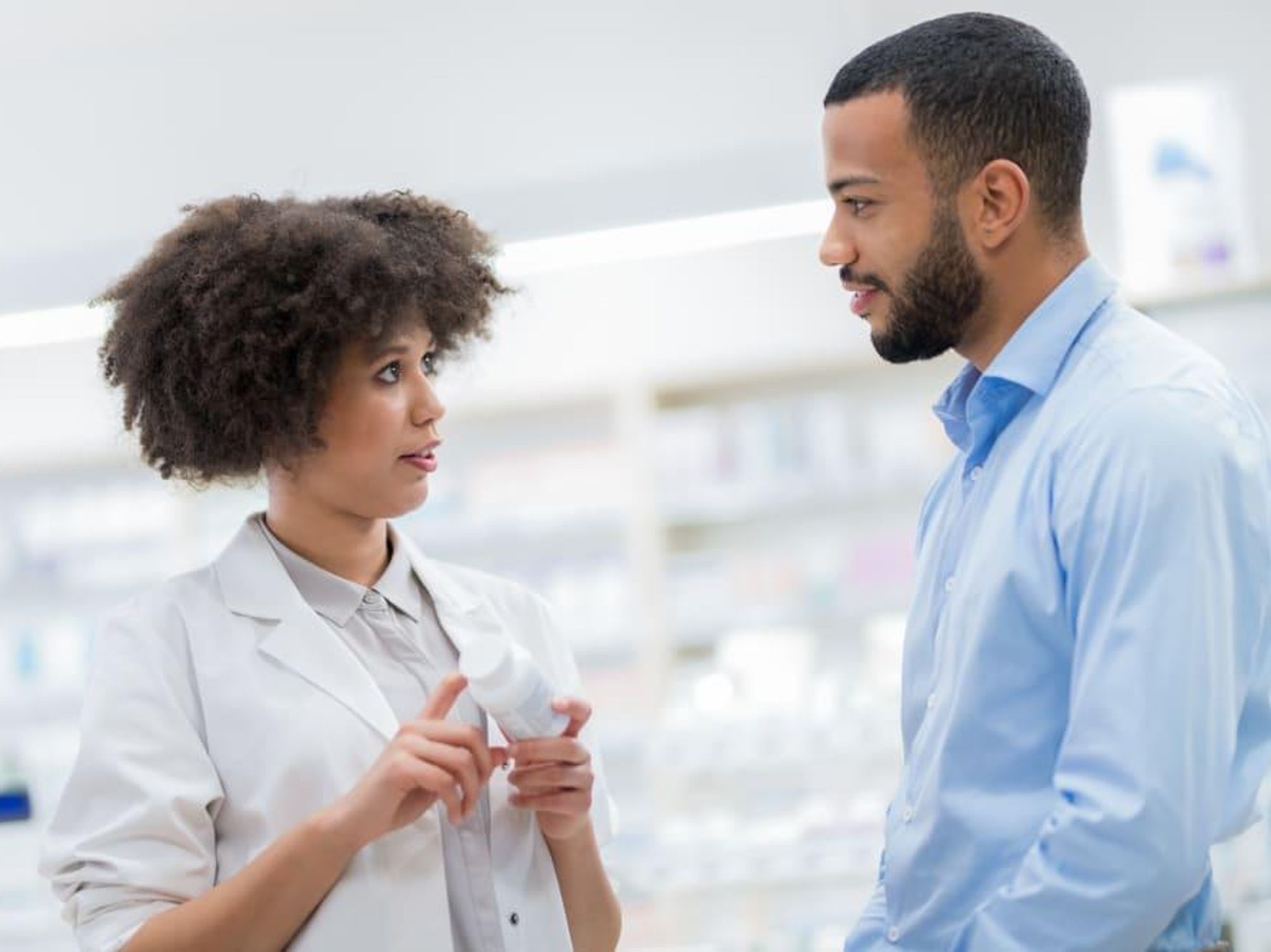Pharmacist talking to man
