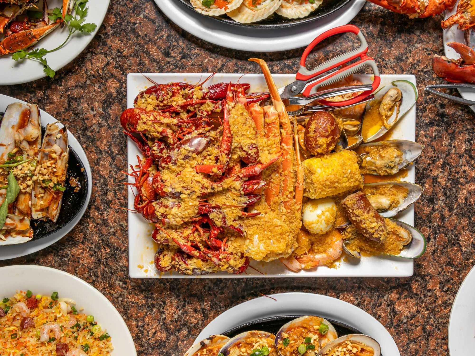 Plates of garlic butter seafood at Ocean Crawfish
