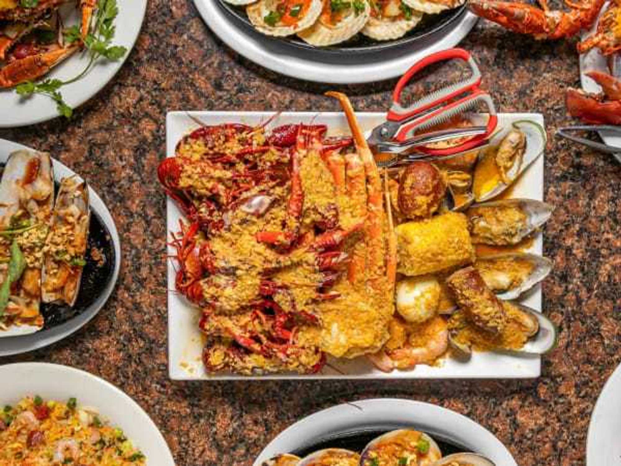 Plates of garlic butter seafood at Ocean Crawfish