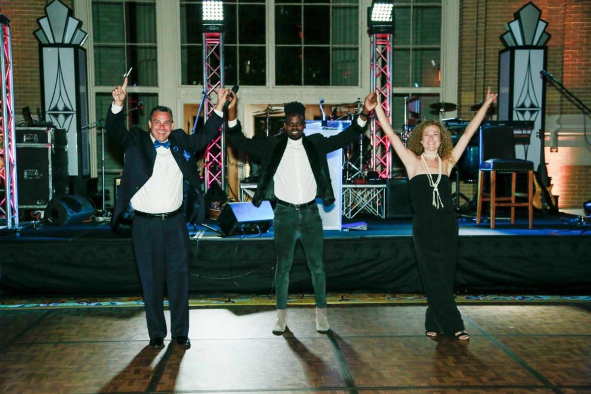 Singer Ron Bultongez with auction winners. CultureMap Dallas