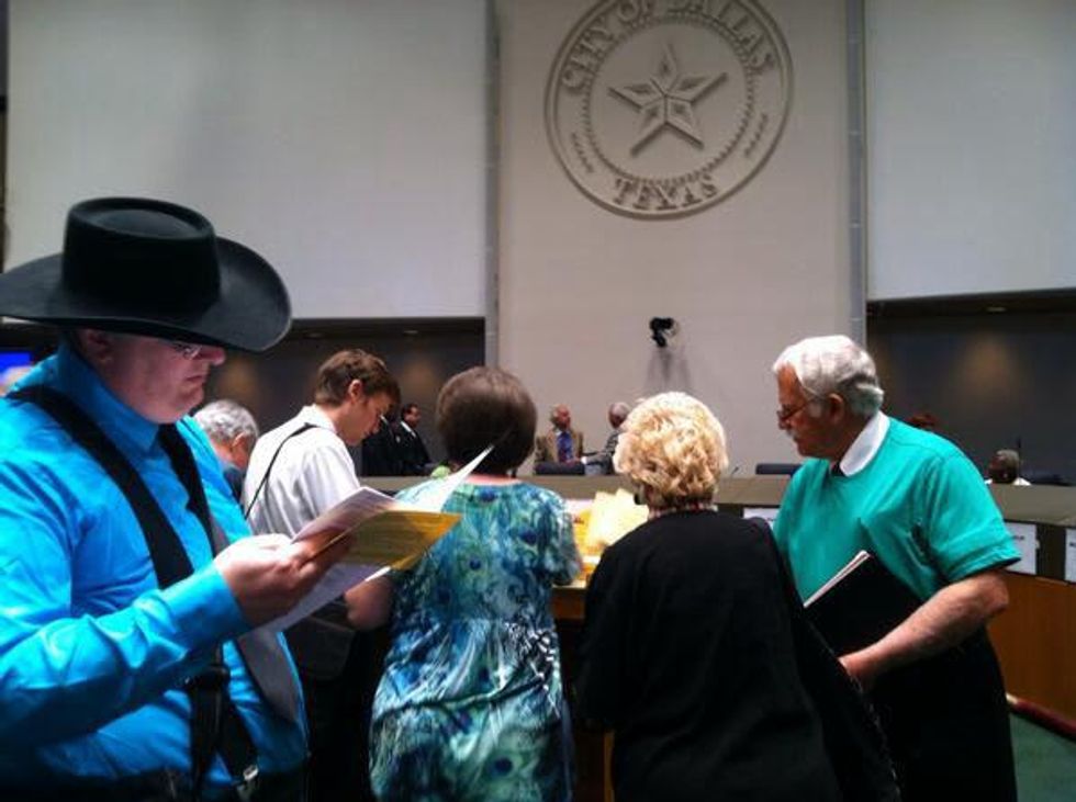 Speakers gather at a public hearing on fracking in Dallas