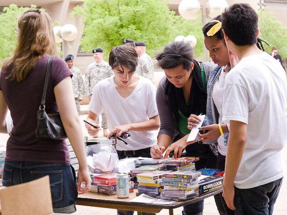 Teens looking at books