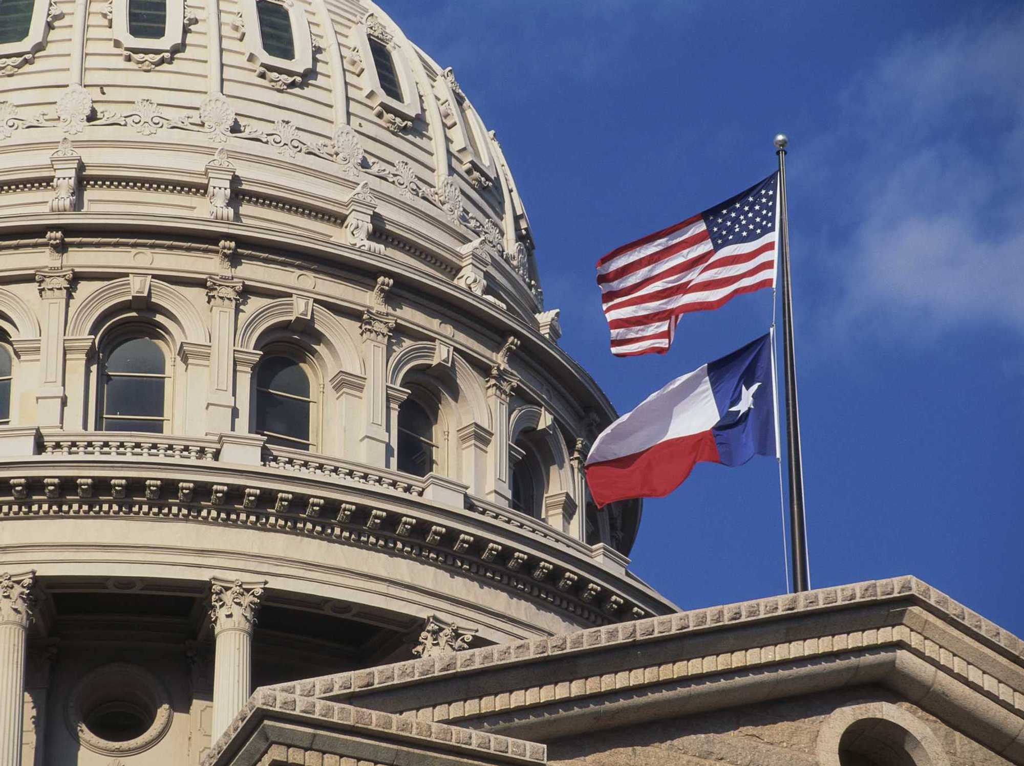 Texas Capitol with state and US flags